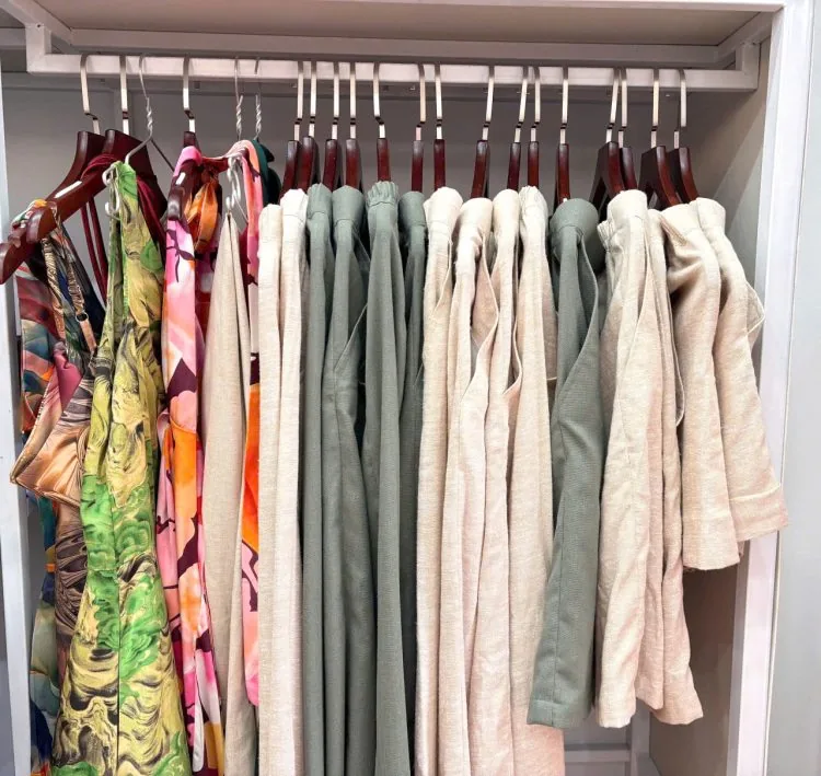 Hanging finished garments and dresses in the Le Loi atelier